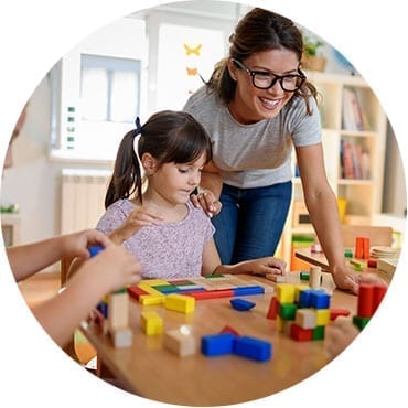 women and daughter with building blocks